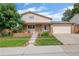 Charming two-story home featuring a well-manicured front yard and attached two-car garage at 7507 Braun St, Arvada, CO 80005