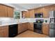 Charming kitchen with wood cabinets, modern appliances, and bright lighting, perfect for cooking at 7507 Braun St, Arvada, CO 80005