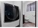 Functional laundry area adjacent to a powder room, featuring modern washer/dryer and coordinated design at 7507 Braun St, Arvada, CO 80005
