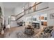Inviting living room boasts a brick fireplace, stairs to a loft, and seamless flow to kitchen and dining area at 7507 Braun St, Arvada, CO 80005