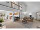 Spacious living room with soaring ceiling, kitchen access and neutral tones offer a cozy atmosphere at 7507 Braun St, Arvada, CO 80005