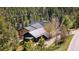 Aerial shot of home nestled among trees, featuring a detached garage and private driveway at 1651 Pine Valley Rd, Evergreen, CO 80439