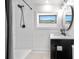 Modern bathroom features a walk-in shower with white subway tiles and a black faucet, plus a black vanity sink at 1651 Pine Valley Rd, Evergreen, CO 80439
