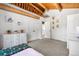 Bright bedroom featuring log beam, chandelier, a dresser, carpet, and a view through the open doorway at 1651 Pine Valley Rd, Evergreen, CO 80439