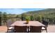 Deck with a wooden table set, perfect for outdoor dining with mountain views at 1651 Pine Valley Rd, Evergreen, CO 80439
