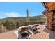 Relaxing deck with lounge chairs overlooking a beautiful mountain landscape at 1651 Pine Valley Rd, Evergreen, CO 80439