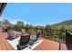 Deck with seating, ideal for outdoor entertaining with picturesque mountain scenery at 1651 Pine Valley Rd, Evergreen, CO 80439