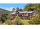 Spacious log home with stone accents, multi-level deck, and mountain views at 1651 Pine Valley Rd, Evergreen, CO 80439