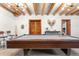 Game room with a pool table and rustic decor at 1651 Pine Valley Rd, Evergreen, CO 80439