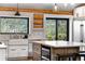 Farmhouse kitchen featuring white cabinets, stone countertops, and stainless appliances at 1651 Pine Valley Rd, Evergreen, CO 80439