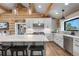 Stylish kitchen featuring white cabinets, subway tile backsplash, and a large island at 1651 Pine Valley Rd, Evergreen, CO 80439