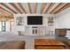 Comfortable living room featuring wooden beams, built-ins, and a cozy couch at 1651 Pine Valley Rd, Evergreen, CO 80439