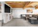Comfortable living room with bright white walls, wooden beams, and a sectional sofa at 1651 Pine Valley Rd, Evergreen, CO 80439