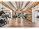 Spacious living room with exposed beams, a stone fireplace, and hardwood floors at 1651 Pine Valley Rd, Evergreen, CO 80439