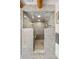 This grey tiled walk-in shower features glass doors, mosaic tile floor, a marble bench, and modern shower fixtures at 1651 Pine Valley Rd, Evergreen, CO 80439