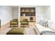 Comfortable basement area with wet bar, modern furnishings, and plush green chairs at 510 Glencoe St, Denver, CO 80220