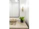 Stylish bathroom featuring a concrete sink, gold fixtures, and a modern light fixture at 510 Glencoe St, Denver, CO 80220