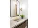 Modern bathroom vanity with a unique sink, stylish mirror, and elegant lighting fixture at 510 Glencoe St, Denver, CO 80220