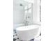 Luxurious bathroom with a freestanding tub, glass shower, and black and white checkered floors at 510 Glencoe St, Denver, CO 80220