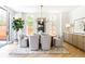 Sunlit dining room featuring a stylish chandelier, modern furniture, and a textured rug at 510 Glencoe St, Denver, CO 80220