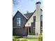 Charming two-story home showcasing a modern design, dark trim, and professional landscaping at 510 Glencoe St, Denver, CO 80220
