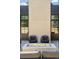 Backyard view of an outdoor seating area with a modern brick fireplace for outdoor entertaining at 510 Glencoe St, Denver, CO 80220