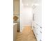 Bright hallway featuring herringbone-patterned wood floors and modern, minimalist cabinetry at 510 Glencoe St, Denver, CO 80220