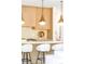 Kitchen island featuring a sleek design, comfortable seating, and stylish pendant lighting at 510 Glencoe St, Denver, CO 80220