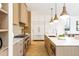 Open kitchen featuring stainless steel appliances, custom cabinetry, and a spacious island at 510 Glencoe St, Denver, CO 80220