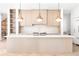 Modern kitchen with a large island, custom cabinetry, and stylish pendant lighting at 510 Glencoe St, Denver, CO 80220