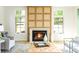 Elegant living room with a fireplace, herringbone floors, and stylish neutral furniture at 510 Glencoe St, Denver, CO 80220