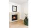 Cozy living room features a modern fireplace with a stone surround and comfortable green chairs at 510 Glencoe St, Denver, CO 80220