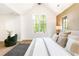 Inviting bedroom with a cozy green chair, large windows, and a comfortable bed setup at 510 Glencoe St, Denver, CO 80220