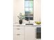 Stylish sink with a window view, complemented by modern cabinetry and sleek hardware at 510 Glencoe St, Denver, CO 80220
