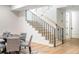 Bright staircase features light hardwood steps, black iron railings, and access to the basement game room at 510 Glencoe St, Denver, CO 80220