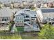 A lush aerial view of a beautiful two-story home showcasing a fenced backyard and neighboring houses at 11584 Pine Canyon Ln, Parker, CO 80138