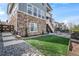 A lush backyard with a small turf area, a wood fence, and lovely hardscape at 11584 Pine Canyon Ln, Parker, CO 80138