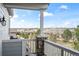 Balcony view featuring stone columns and a scenic view of the surrounding landscape at 11584 Pine Canyon Ln, Parker, CO 80138