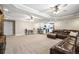 Spacious finished basement with a large leather sectional, kitchenette, tray ceilings, and recessed lighting at 11584 Pine Canyon Ln, Parker, CO 80138