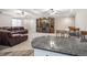 Finished basement featuring a kitchenette island with granite countertops and a large entertainment center at 11584 Pine Canyon Ln, Parker, CO 80138