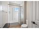 Bright bathroom features a shower-tub combo with a floral curtain and a single window for natural light at 11584 Pine Canyon Ln, Parker, CO 80138