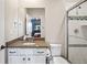 Bathroom with granite counters, white cabinetry, and a shower with glass door at 11584 Pine Canyon Ln, Parker, CO 80138