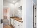 Bathroom with a double sink vanity, white cabinets, and warm tile flooring at 11584 Pine Canyon Ln, Parker, CO 80138