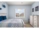 Bright bedroom featuring a large window, decor, and stylish furnishings at 11584 Pine Canyon Ln, Parker, CO 80138