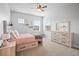 Cozy bedroom with a charming daybed, drawers, and natural light from multiple windows at 11584 Pine Canyon Ln, Parker, CO 80138