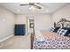 Cozy bedroom showcasing a decorative wrought iron bedframe, a blue dresser and neutral walls and carpet at 11584 Pine Canyon Ln, Parker, CO 80138