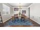 Elegant dining room with a wooden table, stylish rug, and decorative chandelier and wall art at 11584 Pine Canyon Ln, Parker, CO 80138