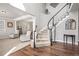 Grand entryway featuring a curved staircase, hardwood floors, and an open layout, creating a welcoming ambiance at 11584 Pine Canyon Ln, Parker, CO 80138