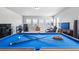 Bright game room with pool table, speakers, and a cozy seating area near the windows at 11584 Pine Canyon Ln, Parker, CO 80138