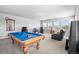 Spacious game room boasts a pool table, comfortable seating, and ample natural light at 11584 Pine Canyon Ln, Parker, CO 80138